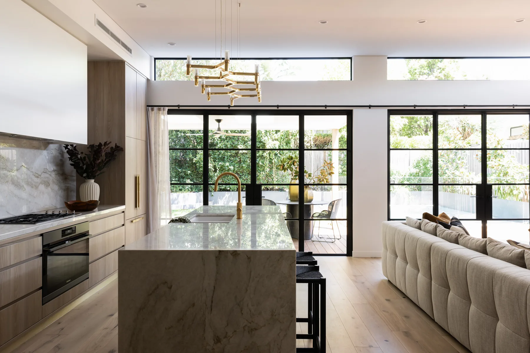 Russell Lea &mdash; open kitchen with stone island, brass pendant and steel-framed windows