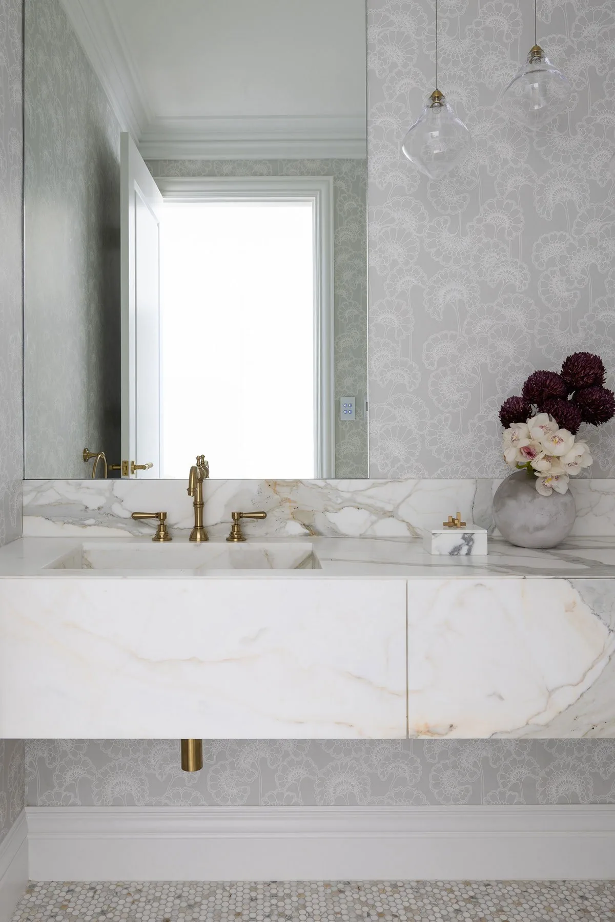 Elanora &mdash; powder room with floating marble vanity and patterned wallpaper