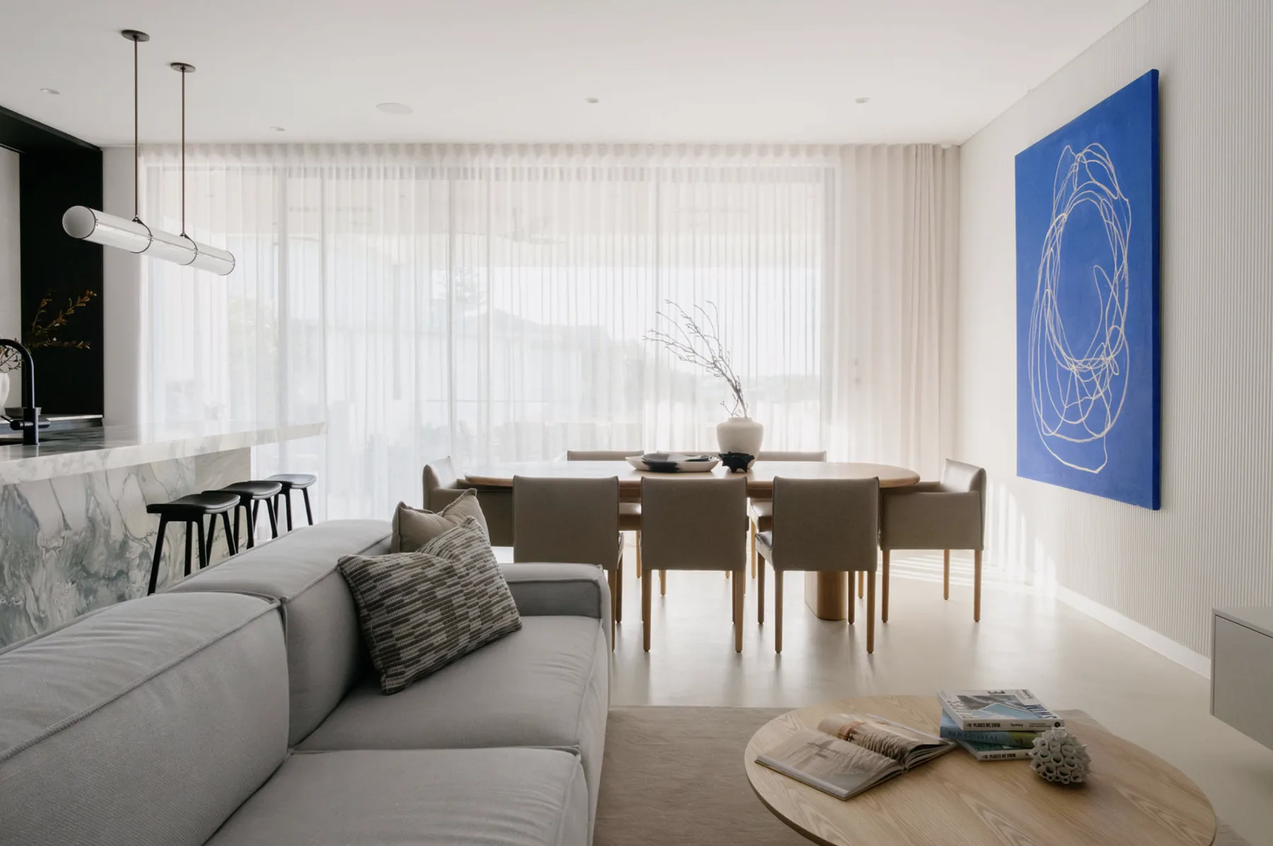 Freshwater &mdash; open-plan living and dining with grey modular sofa and blue abstract artwork