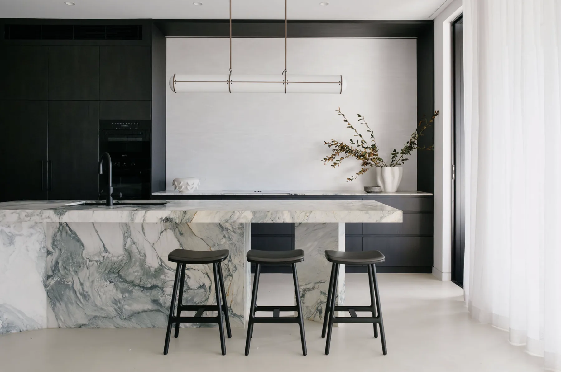 Freshwater &mdash; kitchen with dark oak joinery and a marble waterfall island with black stools