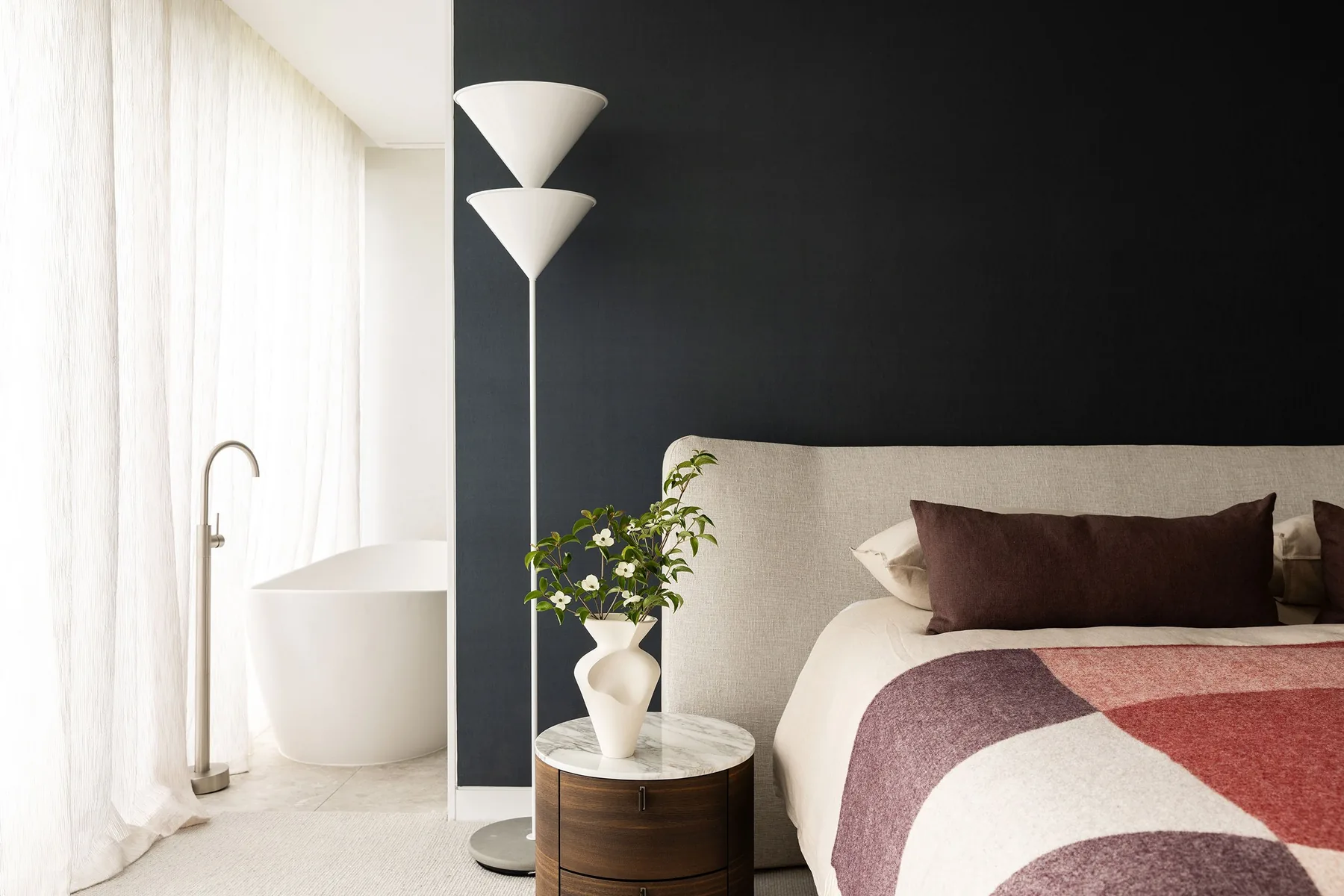 Mosman 02 &mdash; main bedroom with charcoal feature wall, patterned bed linen and freestanding bath